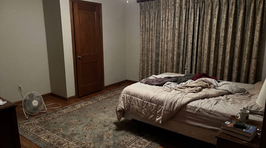 Closed bedroom with soft surfaces and low airflow that can make indoor air feel stale